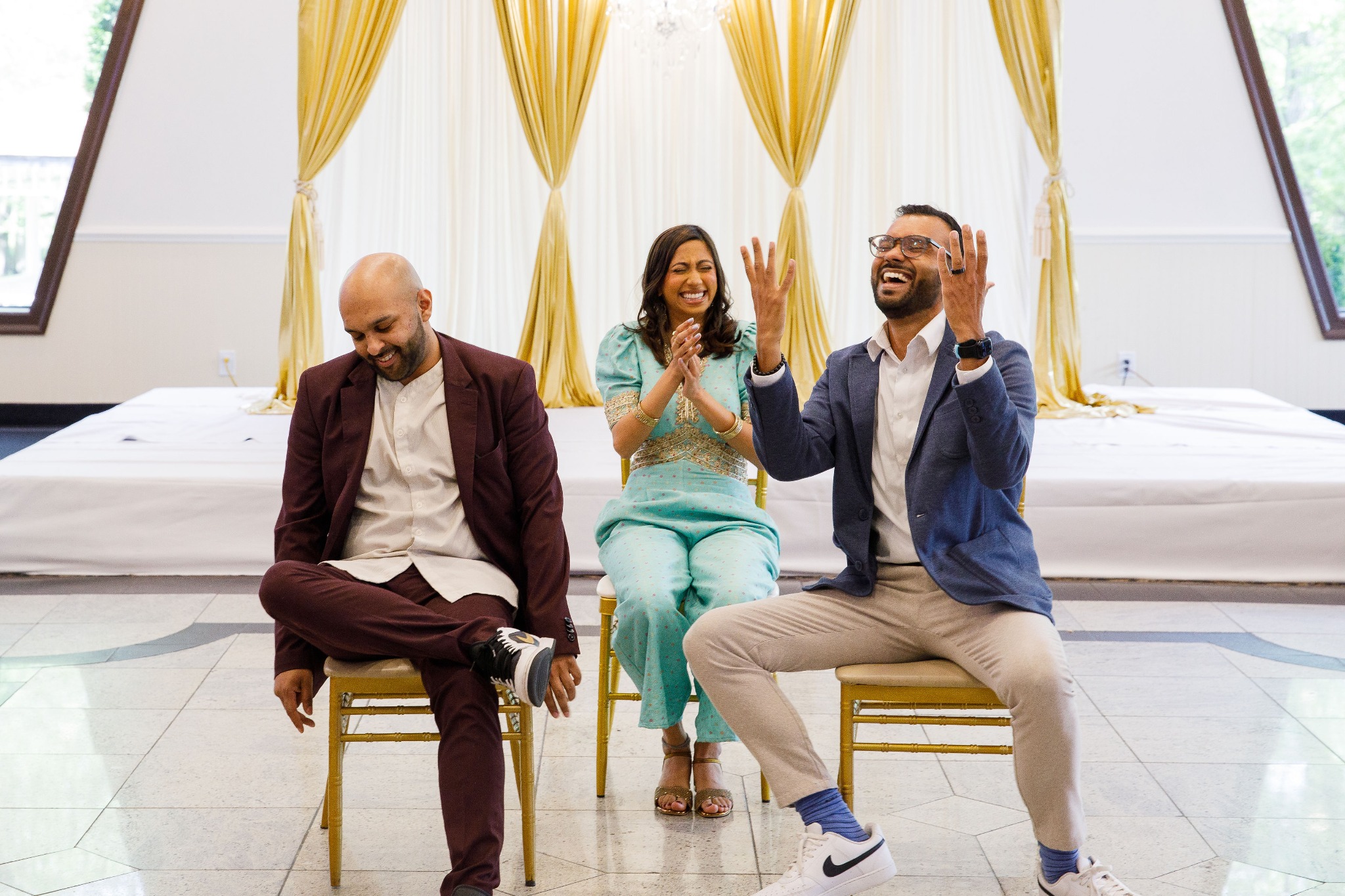 Priya laughing with her brothers at a family celebration