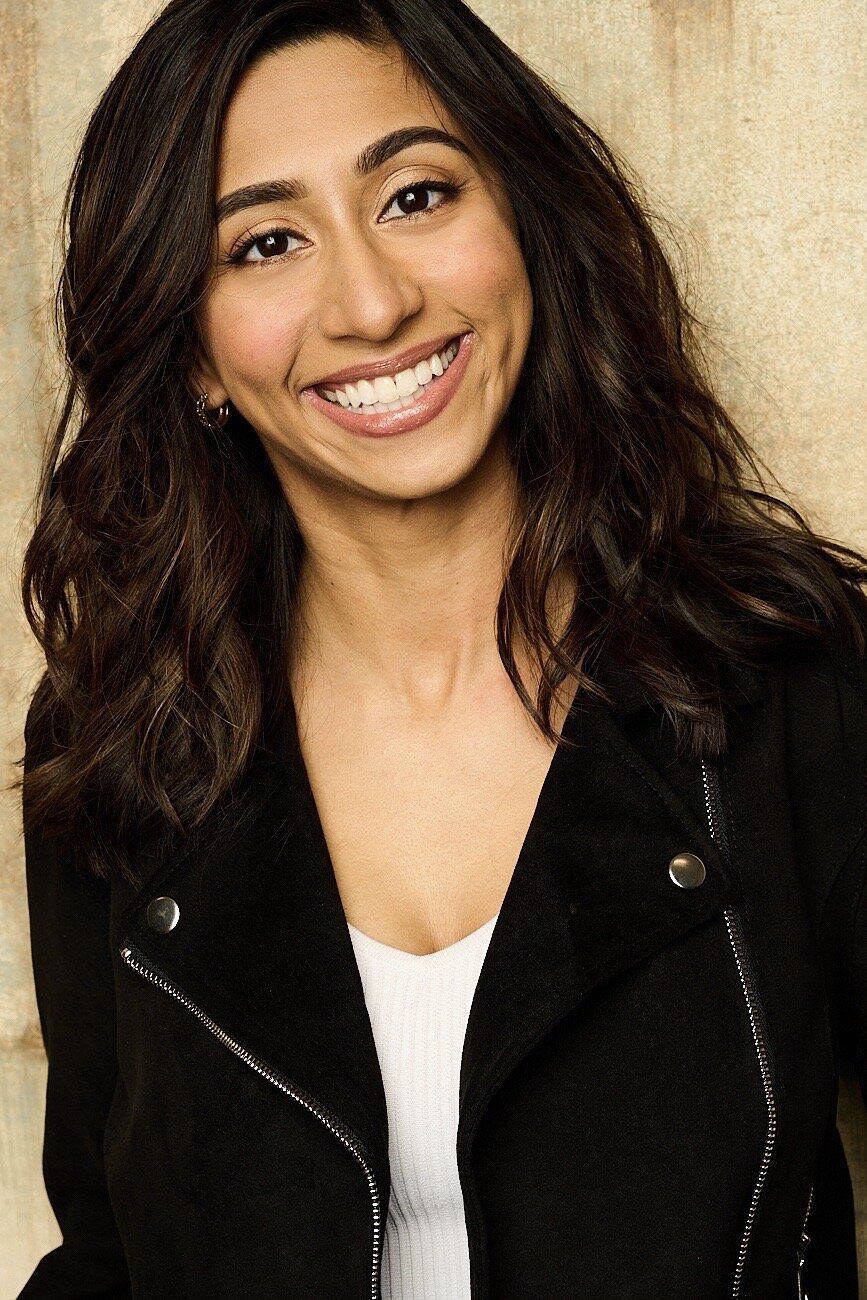 Priya Mehta smiling in a black jacket